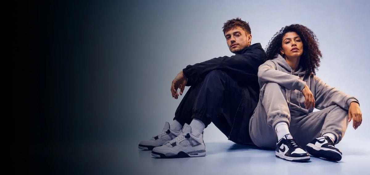 Man and woman wearing sneakers in a studio campaign setting